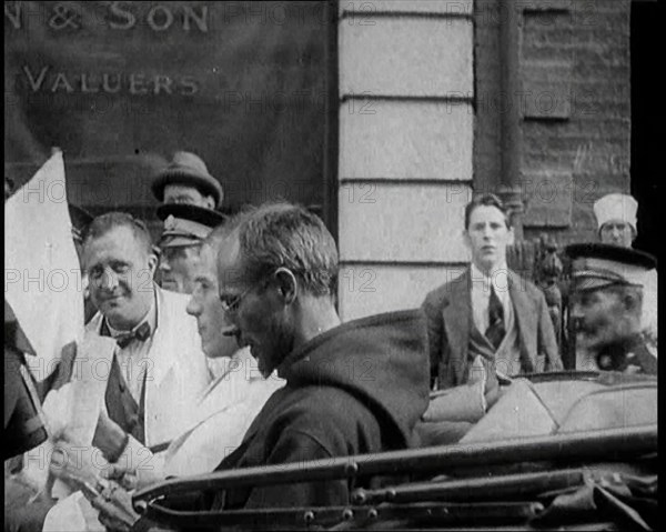 An Irish Priest Talking to a Soldier in a Car, Trying to Bring Peace, 1922. Creator: British Pathe Ltd.