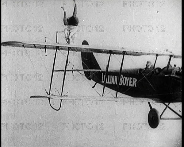 Lilian Boyer Performing Acrobatic Feats from a Flying Biplane, 1922. Creator: British Pathe Ltd.