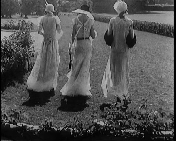 A Group of Three Female Civilians Wearing Fashionable Clothes Standing in a Garden, 1929. Creator: British Pathe Ltd.