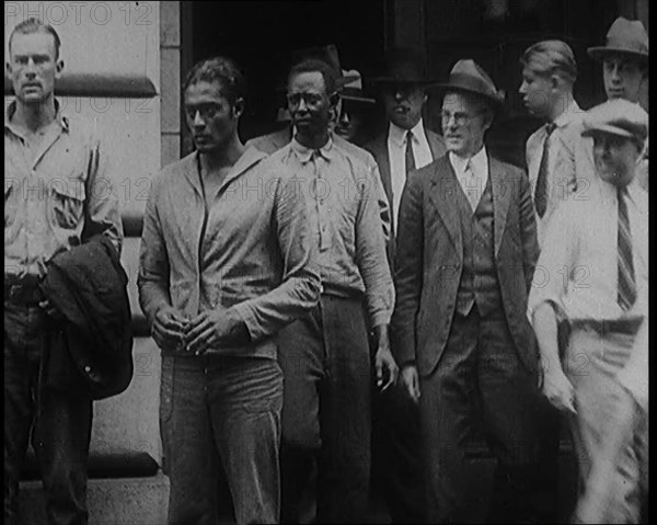 Alcohol Smugglers Coming Out of Court, 1929. Creator: British Pathe Ltd.