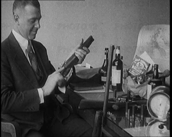 Male Detective Showing off Smugglers' Captured Guns, 1929.  Creator: British Pathe Ltd.