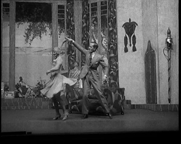 Scene from a Stage Show: Male and Female Civilian Dancing on a Stage in a Routine with..., 1929. Creator: British Pathe Ltd.