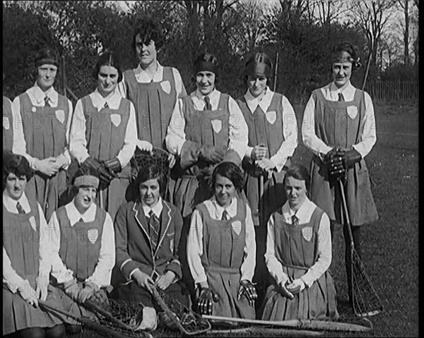 A Group of Young Female Civilians Wearing Gymslips Holding Lacrosse Sticks, 1920. Creator: British Pathe Ltd.