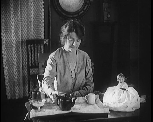 Female Civilian Seating at a Table Serving Tea, 1920. Creator: British Pathe Ltd.