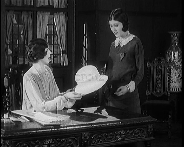 Two Female Civilians in a Drawing Room Having a Conversation About a Hat One of Them Is Holding,1920 Creator: British Pathe Ltd.