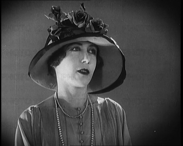 Female Civilian Modelling a Hat Decorated with Flowers, 1920. Creator: British Pathe Ltd.