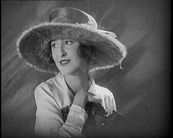 Female Civilian Modelling a Hat Decorated with a Ribbon and Fur, 1920. Creator: British Pathe Ltd.