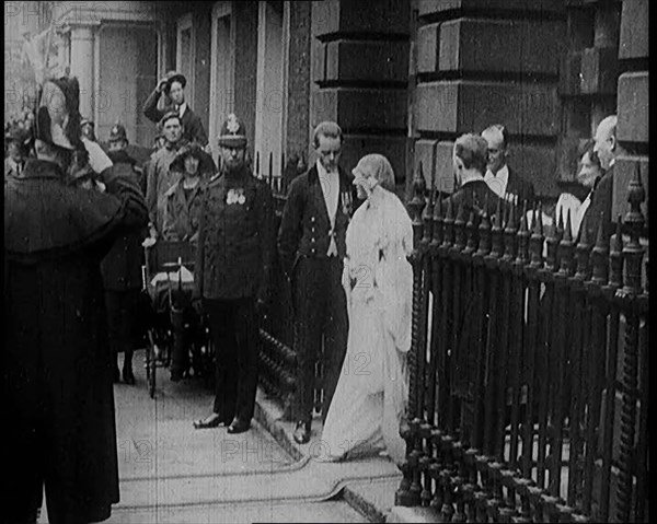 The Duke of York and Lady Elizabeth Bowes-Lyon Emerging from a House on Their Wedding Day, 1920. Creator: British Pathe Ltd.