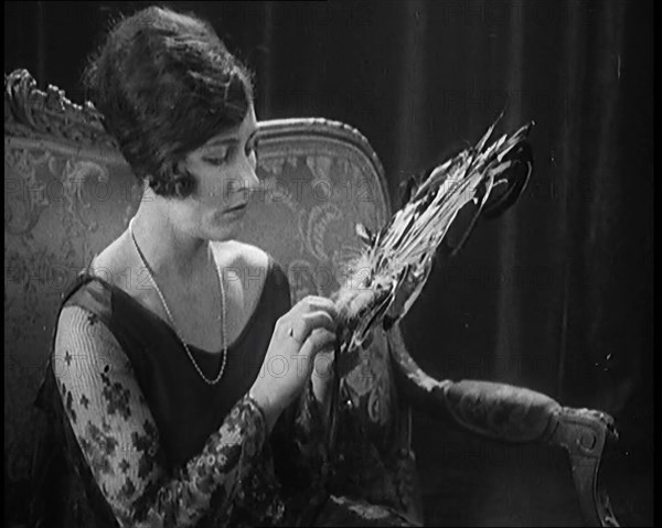 Female Civilian Seating Handling a Fan Made of Feathers, 1920. Creator: British Pathe Ltd.