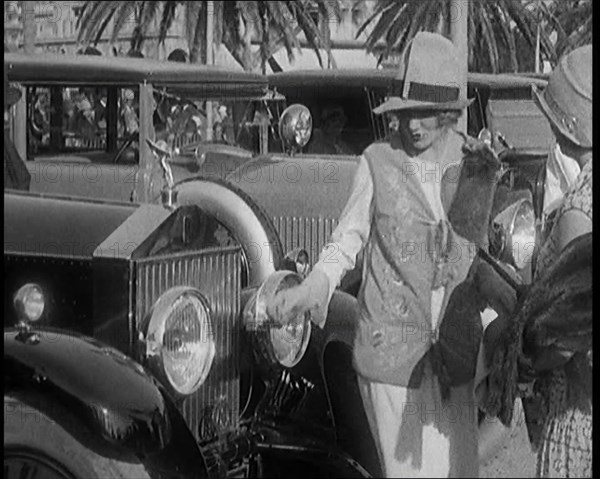 Two Female Civilians Wearing Glamorous Outfits Admiring a Luxurious Car, 1920. Creator: British Pathe Ltd.