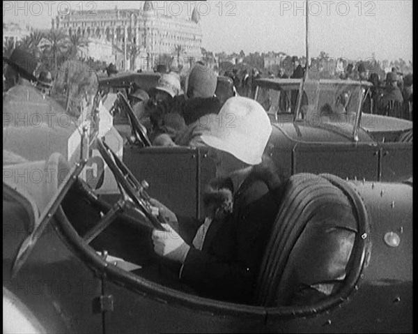 Female Civilian Wearing a Fur Trimmed Coat and Hat Sitting Behind the Wheel of a Car, 1920. Creator: British Pathe Ltd.