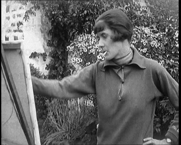 A Female Civilian Painting at an Easel Outdoors Smoking a Cigarette, 1920. Creator: British Pathe Ltd.