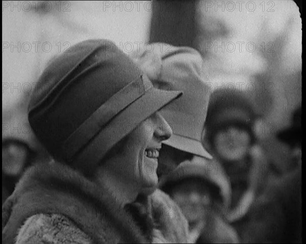 Two Female Civilians Wearing Heavy Coats and Hats Standing in Front of a Car, 1920. Creator: British Pathe Ltd.