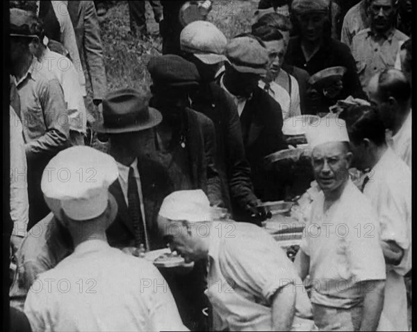 American Civilians Serving Meals for a Large Crowd on a Queue Outdoors, 1930. Creator: British Pathe Ltd.