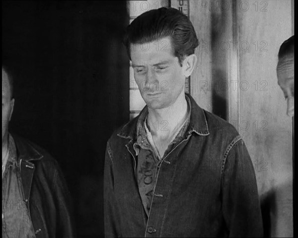 A group of Male Americans Civilians Wearing Prisoners Outfits Being Escorted Into a Room..., 1930. Creator: British Pathe Ltd.