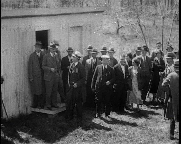 American Police Officers and Civilians in a Cemetery During a Kidnapping Investigation, 1930s. Creator: British Pathe Ltd.