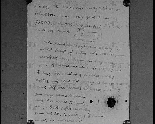 Notes of Ransom Being Shown as Articles of Evidence in the Lindbergh's Kidnapping Case Trial, 1930s. Creator: British Pathe Ltd.