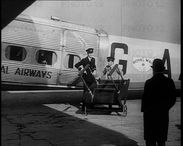 Three Men Tending to a Plane on the Ground, 1933. Creator: British Pathe Ltd.