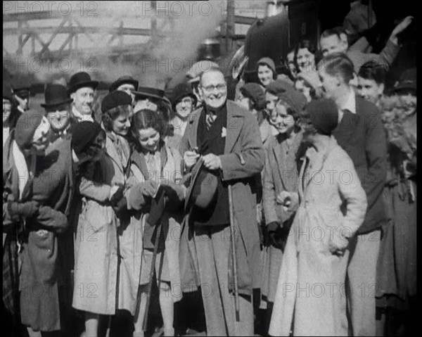 People Standing at  a Train Station, 1933. Creator: British Pathe Ltd.