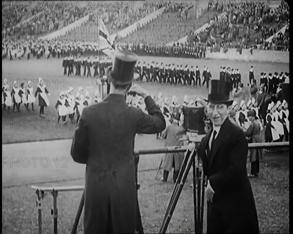 Male Newsreel Camera Operators Carrying Tripods and Equipment, 1920s. Creator: British Pathe Ltd.