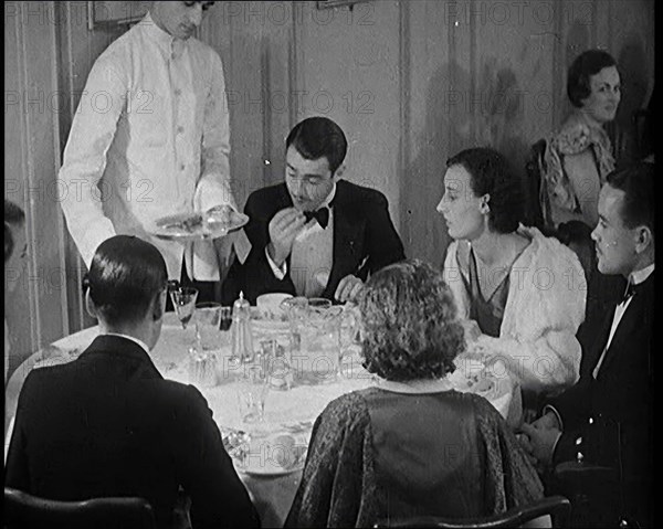 Upper Class People Enjoying a Meal in a Restaurant, 1931. Creator: British Pathe Ltd.