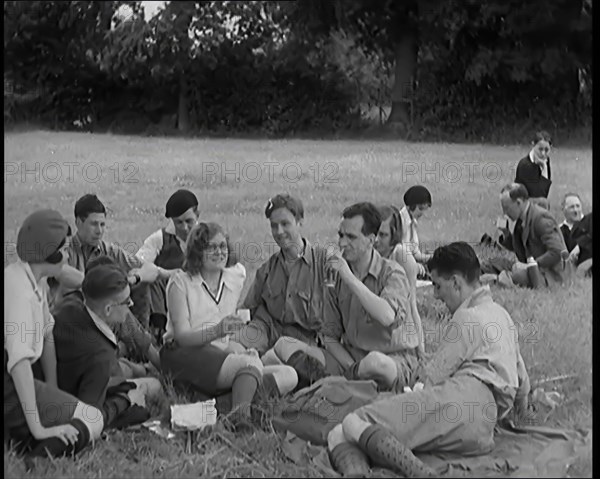 A Large Group of Hikers Having Drinks in a Field, 1931. Creator: British Pathe Ltd.