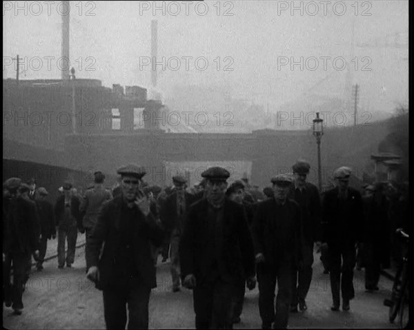 Crowd of Men Walking Through the Street Towards the Camera, 1933. Creator: British Pathe Ltd.