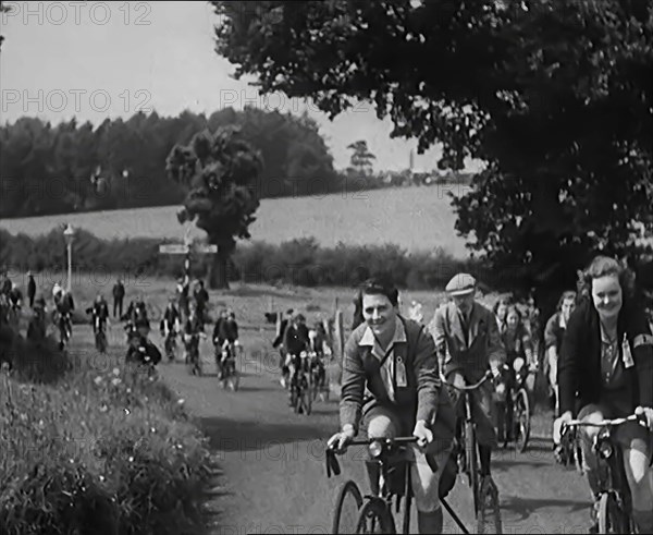 Large Group of Civilians Riding Bicycles Through Country Lanes, 1931. Creator: British Pathe Ltd.