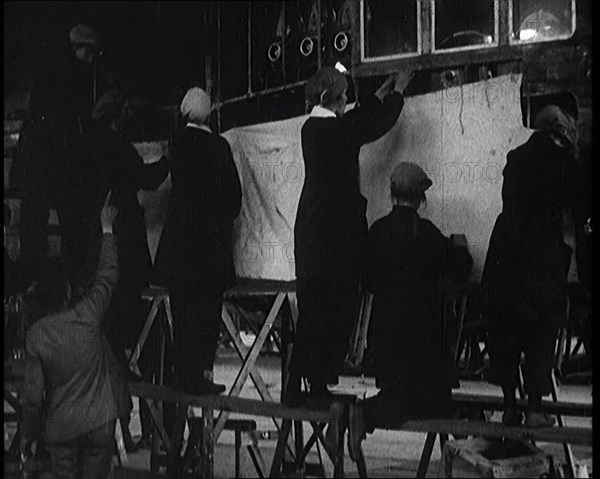 Men and Women Building the Body of the Cockpit of an R 38 Airship in a Hangar, 1921. Creator: British Pathe Ltd.