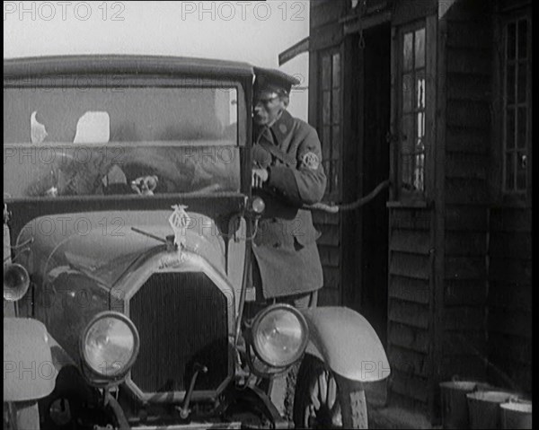 A British Automobile Association Employee Filling a Car With Petrol at the First Petrol Station,1920 Creator: British Pathe Ltd.