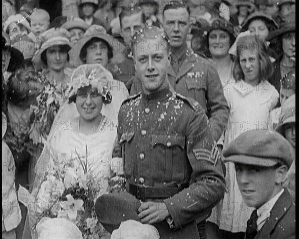 British Bride and Groom Smiling for the Camera at Their Wedding, 1921. Creator: British Pathe Ltd.