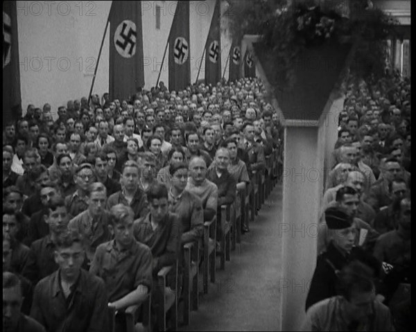 People Watching an  Orchestra with Nazi Flags on the Walls, 1937. Creator: British Pathe Ltd.