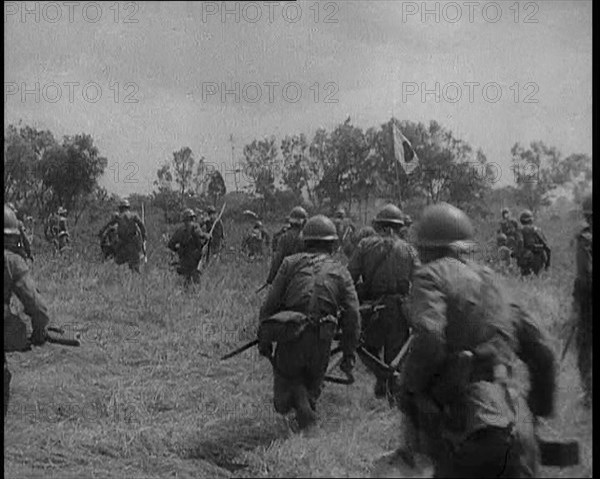 Japanese Soldiers Running Through a Field, 1933. Creator: British Pathe Ltd.