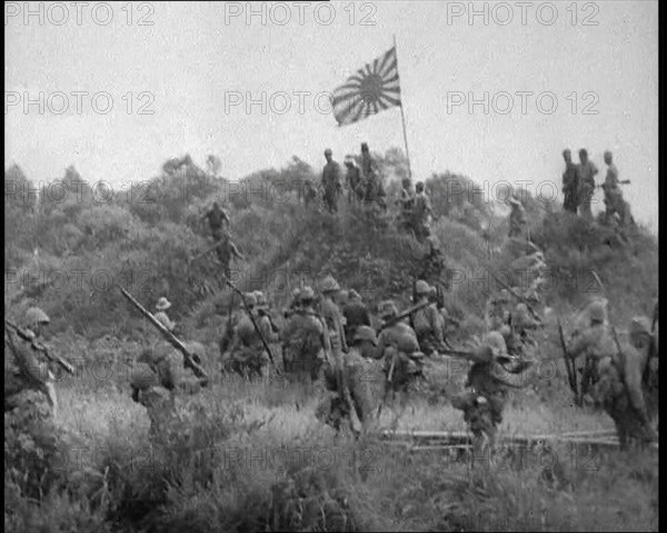 Japanese Soldiers Gathering Around the Japanese Flag, 1933. Creator: British Pathe Ltd.