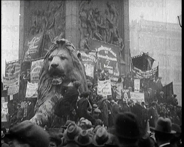 People Climbing Over the Lions at the Foot of Nelson's Column in Trafalgar Square, London..., 1922. Creator: British Pathe Ltd.