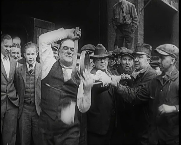 A Male Stuntman Bending Iron Bars Around His Head, 1926. Creator: British Pathe Ltd.