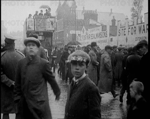 Packed Pavement on a British Street. Behind the Pedestrians Is a Sign Reading 'Site for..., 1921. Creator: British Pathe Ltd.