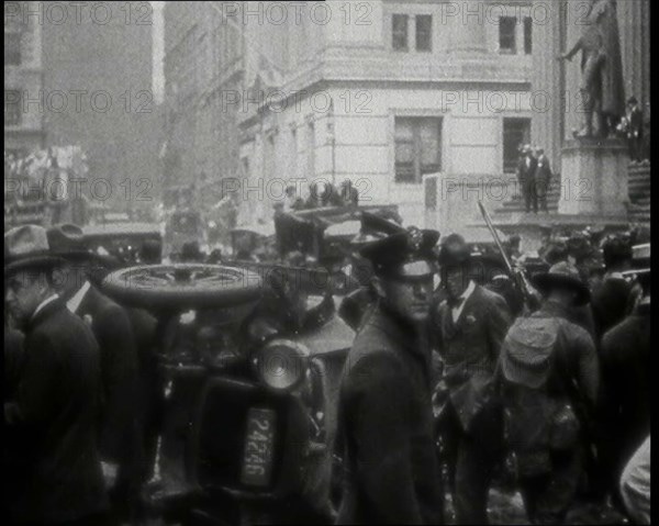 Police Looking Over Overturned Vehicles in New York City After a Bomb Was Thrown at the..., 1920. Creator: British Pathe Ltd.