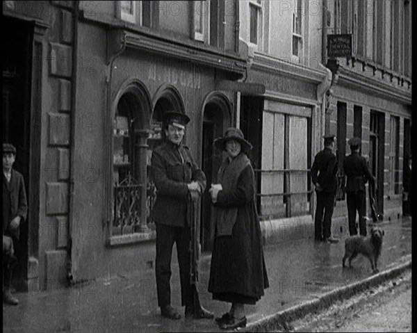 People Walking Along a Desolate Street in Ireland, 1921. Creator: British Pathe Ltd.