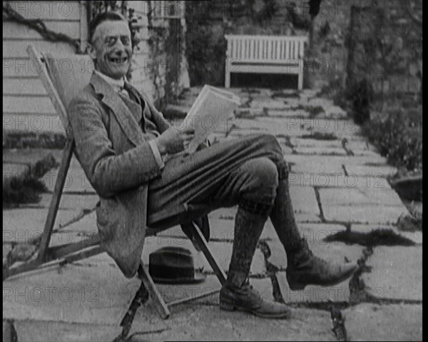 British Chancellor of the Exchequer Joseph Austen Chamberlain Reading a Newspaper While..., 1920. Creator: British Pathe Ltd.