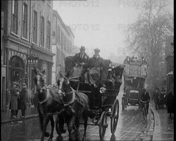 Vehicles Passing Along a Busy British Street, 1921. Creator: British Pathe Ltd.