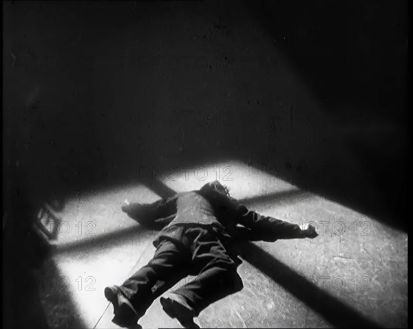 Scene from the Film 'The Informer':  Lars Hansen Falling Down Dead in a Church After..., 1920s. Creator: British Pathe Ltd.