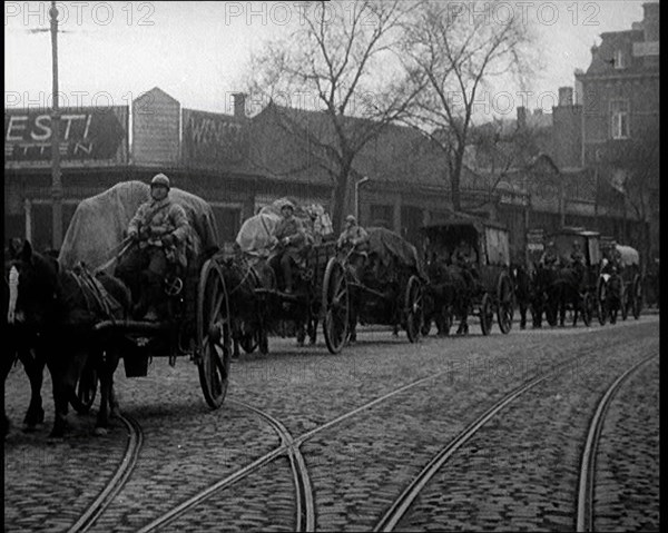 French Soldiers Escort Wagons Down a Cobbled Street, 1924. Creator: British Pathe Ltd.