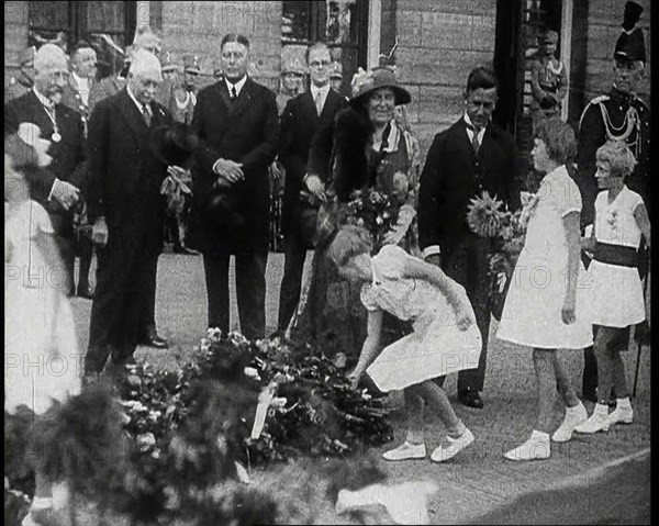 Young Girls Leaving Flowers in a Pile for Wilhelmina, Her Majesty the Queen of the Netherlands,1930s Creator: British Pathe Ltd.