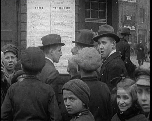 German People Reading a Poster up on a Wall, 1921. Creator: British Pathe Ltd.