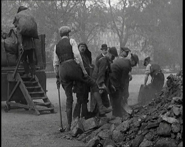 Male Civilian Volunteers Shovelling Heaps of Coal in Hyde Park London, 1926. Creator: British Pathe Ltd.