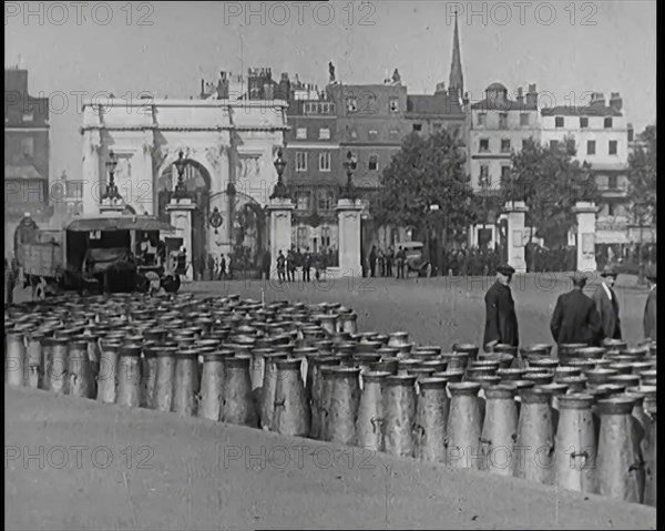 Milk Churns Lining the Street, 1926. Creator: British Pathe Ltd.