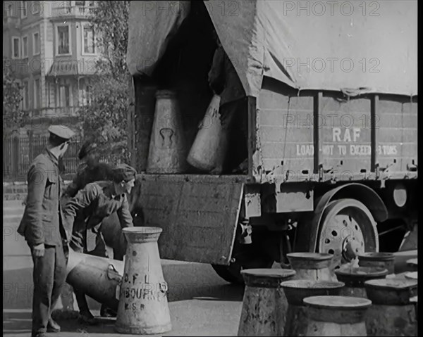 Milk Churns Being Loaded Onto a Lorry by Male Soldiers, 1926. Creator: British Pathe Ltd.