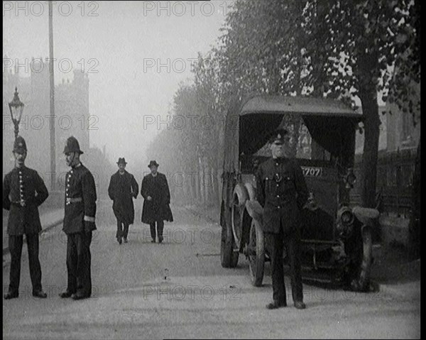 Two Vicars Walking Past Policemen Outside Brixton Prison, 1920. Creator: British Pathe Ltd.