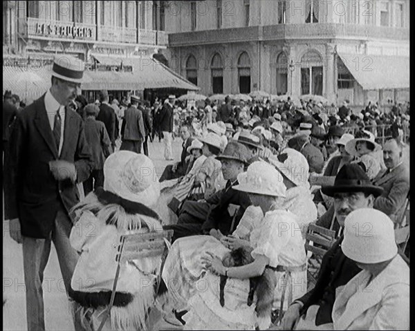 Scene from the Film 'The Compulsory Husband': Crowds of Holiday Makers Sitting at Out..., 1920s. Creator: British Pathe Ltd.